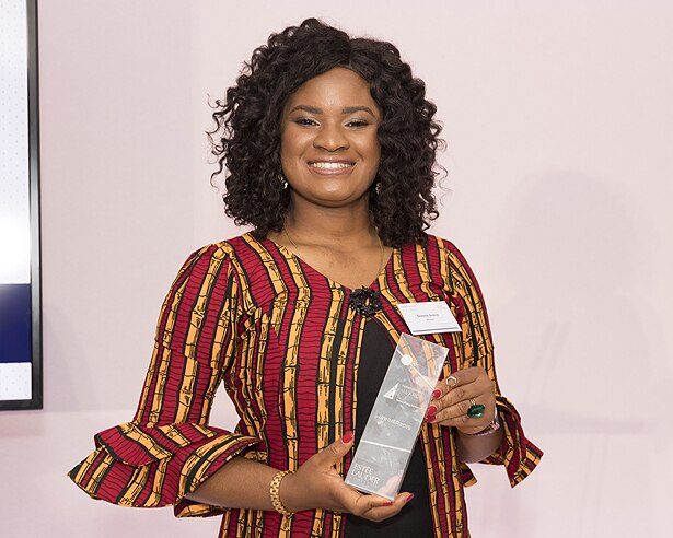 Woman smiling holding an award